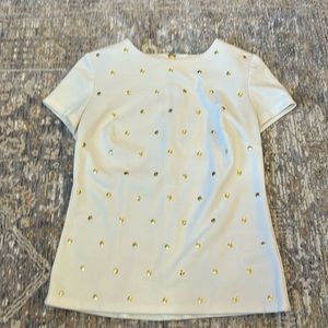 Michael Kors white top with gold accents.